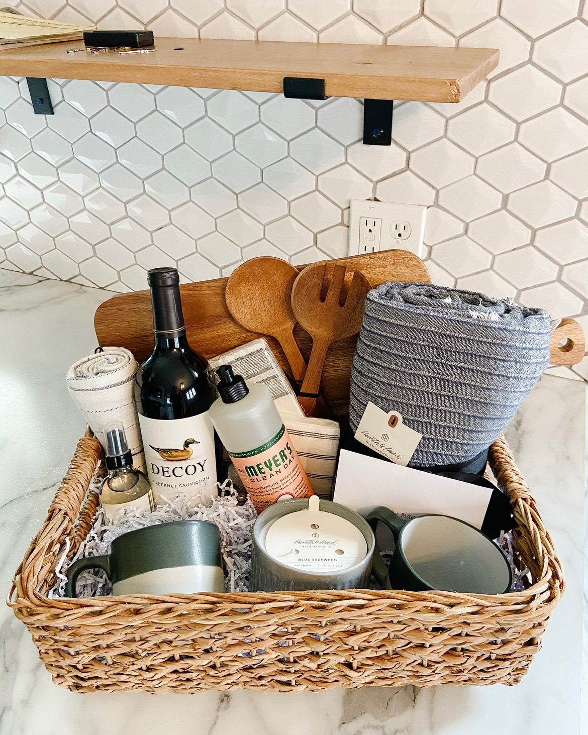 a basket with gifts an dlocal products in it to be a housewarming gift